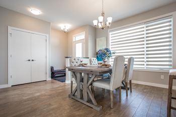 A dining room with a table set for four.